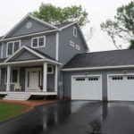 NH Manufactured home with 2-Story with attached garage and shed roof porch with dormer