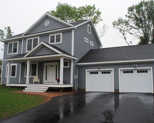 2-Story manufactured home with attached garage and shed roof porch with dormer